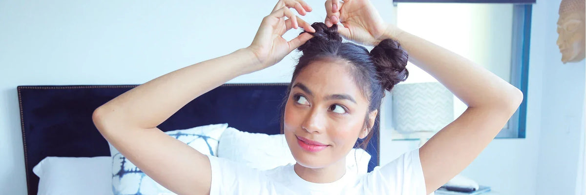 Woman with 2 buns in her hair. 