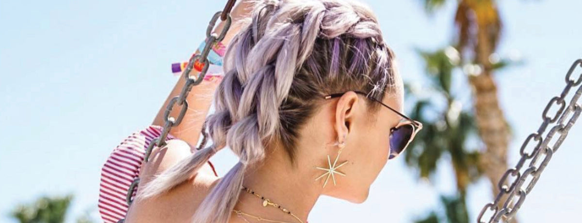 Image of a model with purple hair in pull through braided pigtails. 