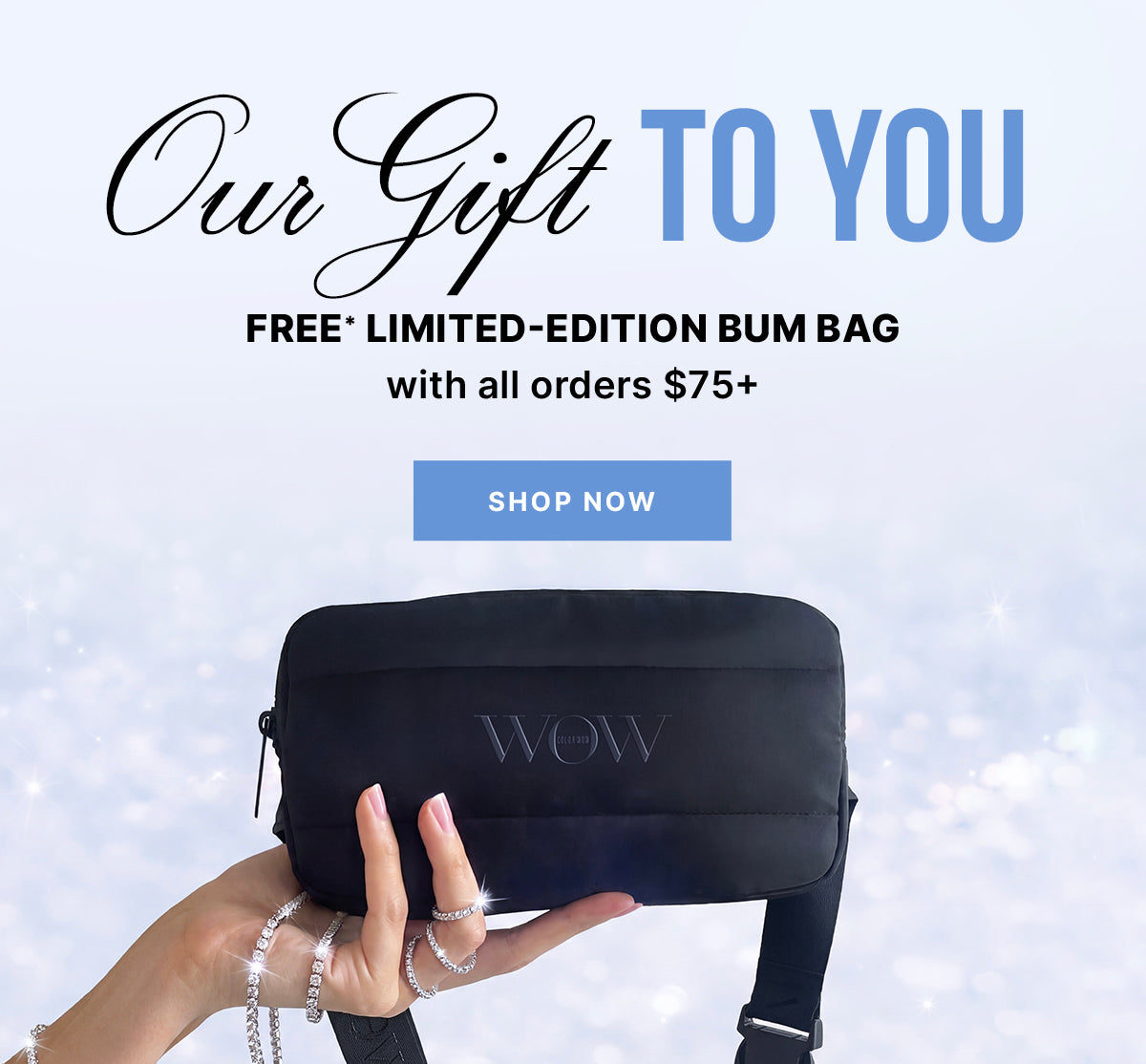 A hand holding a black Color Wow bum bag against a sparkling background. Text: Our Gift to You—free limited-edition bum bag with all orders of $75 or more. Shop now.